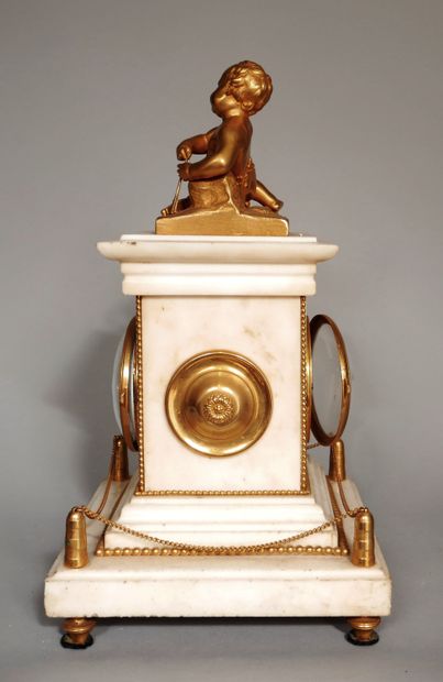 null A white marble clock consisting of a cube resting on a square base decorated...