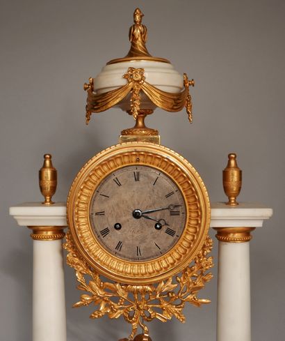 null Portico clock in white marble and ormolu resting on five bronze feet, the dial...