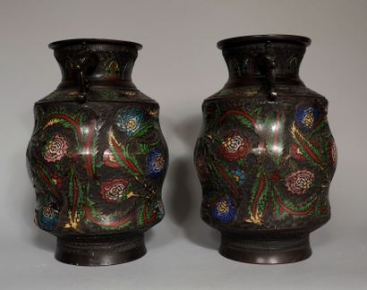 null A pair of patinated bronze and polychrome cloisonné bronze vases with handles,...