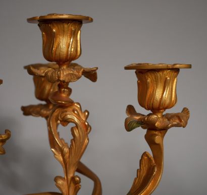 null A pair of bronze candelabras with four arms of lights carved with rocaille,...
