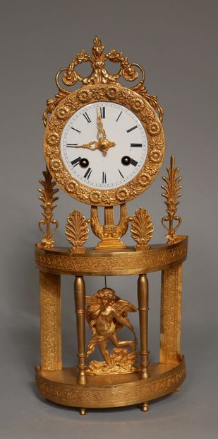 null Small gilt bronze and brass portico clock with palmettes, lyre, Eros, wire movement...