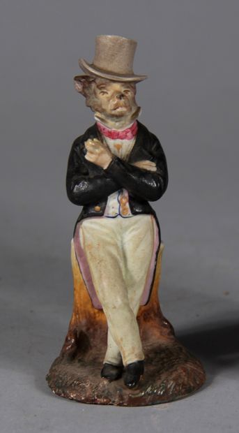 null Lot :

- Petit vase en biscuit polychrome à décor d'un loup habillé en dandy

H...