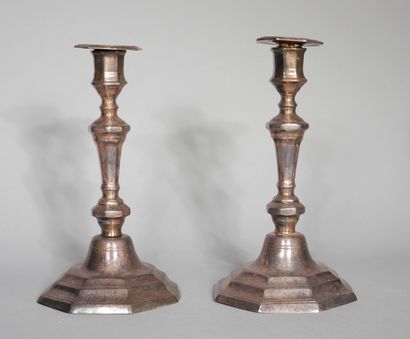 null Two pairs of silver-plated candlesticks, one with a moving base, the other with...