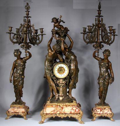 null A Sienna marble veneer mantel set with a clock and a pair of candelabras decorated...
