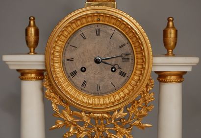 null Portico clock in white marble and ormolu resting on five bronze feet, the dial...