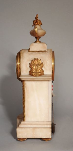 null Alabaster and bronze clock surmounted by a flowering urn with two handles, four...