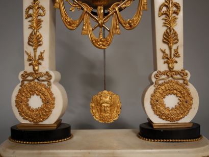 null A white marble and ormolu portico clock resting on four feet, the movement surmounted...