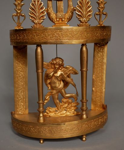 null Small gilt bronze and brass portico clock with palmettes, lyre, Eros, wire movement...