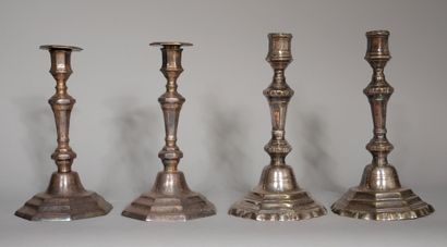 null Two pairs of silver-plated candlesticks, one with a moving base, the other with...