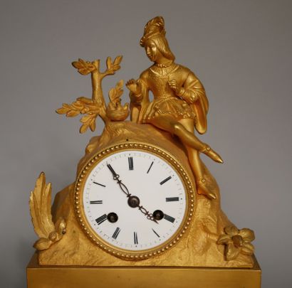 null A romantic ormolu and brass quadripod clock, the movement surmounted by a courtier...