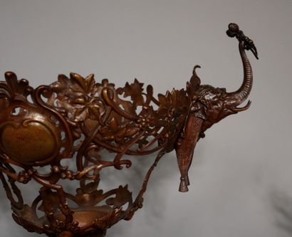 null A large four-legged punch bowl on a pedestal in patinated and openwork metal...