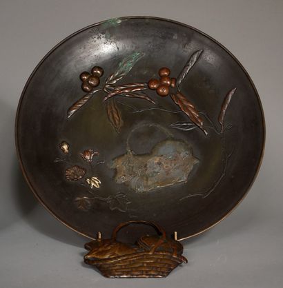 null Two patinated bronze dishes decorated in relief with a bird and a basket among...