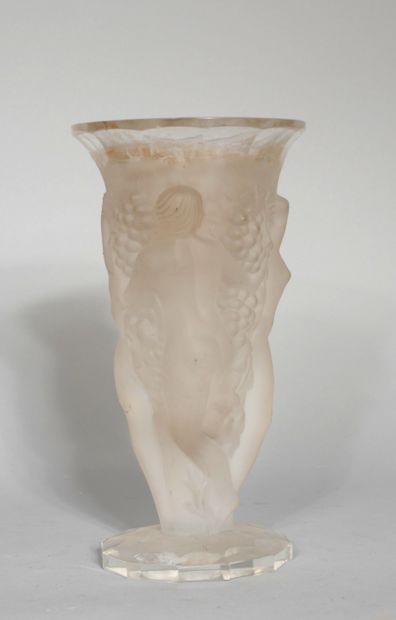 null A transparent and frosted moulded glass vase with a bacchanalian scene in relief...