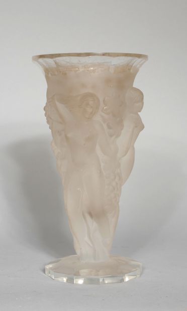 null A transparent and frosted moulded glass vase with a bacchanalian scene in relief...