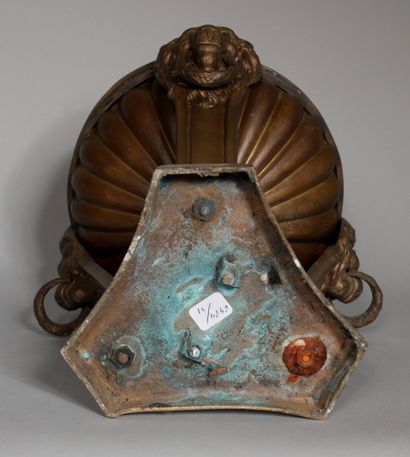 null A tripod patinated bronze incense burner with lion's head handles and a flame-shaped...