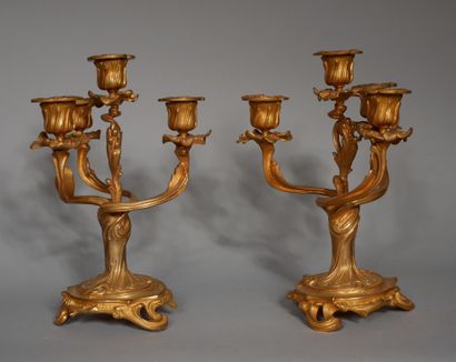 null A pair of bronze candelabras with four arms of lights carved with rocaille,...