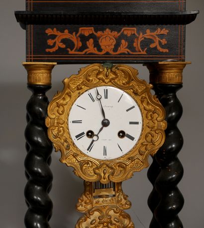 null An ebony veneered portico clock with twisted columns, inlaid with scrolls and...