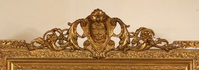 null A stuccoed wood window with a medallion pediment surrounded by foliage.

150...