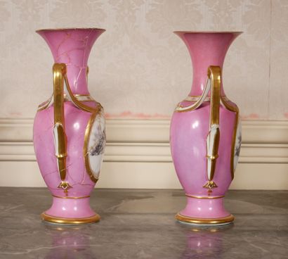 null A pair of two-handled vases in pink porcelain, gilded and decorated with medallions...