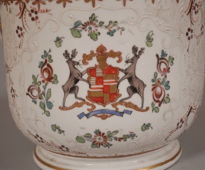null A polychrome and gilded porcelain pot with handles decorated with a coat of...