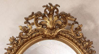 null Oval gilded stuccoed wood window with rocaille pediment, late 19th c.

120 x...