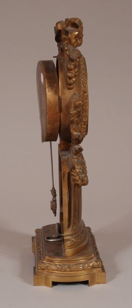 null Pendule en bronze en forme de colonne ajourée surmontée par le mouvement entouré...