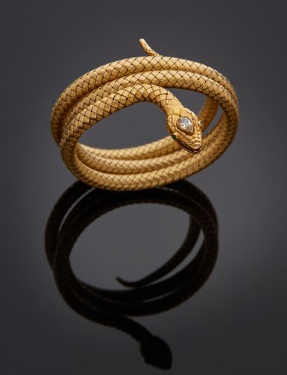 null Yellow gold bracelet (ET) featuring a coiled snake, the head adorned with a...
