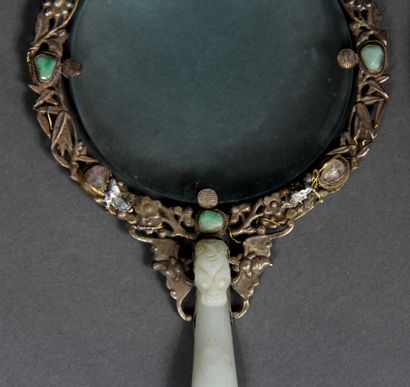 null Lot comprenant :

- un miroir orné d'une fibule en jade dont l'extrémité se...