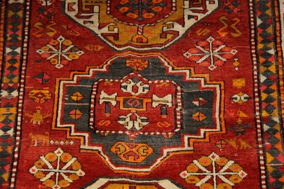 null Polychrome wool carpet decorated with three medallions with stylized decoration...