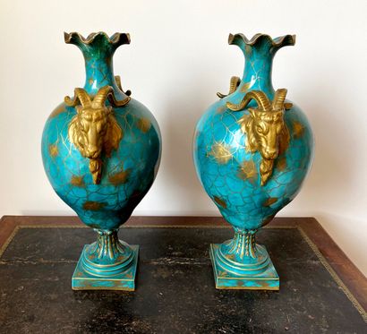 null A pair of blue and gold glazed porcelain baluster vases on pedestal with goat...