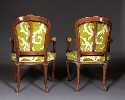 null A pair of Louis XV style cabriolets armchairs in natural wood carved with flowers.

Seat...