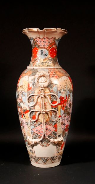 null A polychrome and gilded earthenware baluster vase decorated with characters...