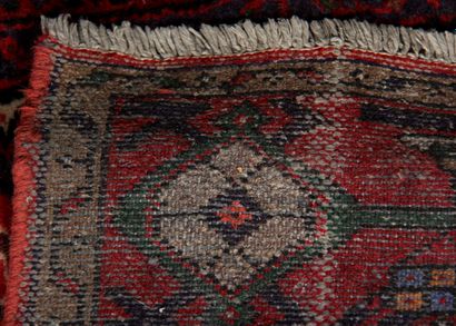 null Polychrome wool carpet decorated with a central hexagonal medallion on a red...
