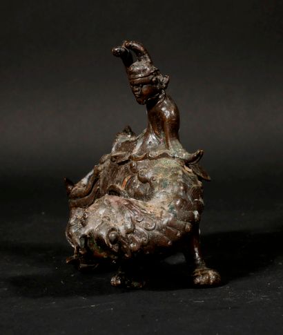 null Patinated metal sculpture in the form of a character on a dog, China

H : 13,5...