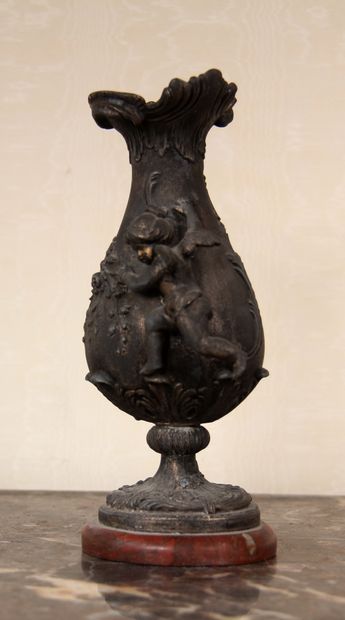 null Vase on metal pedestal with relief decoration of an angel and foliage, red marble...