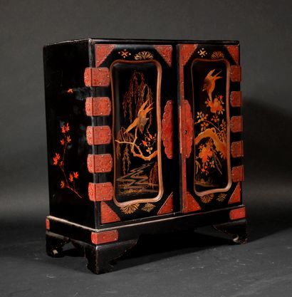 null Black lacquered wood cabinet with gilded decoration of birds and branches, the...