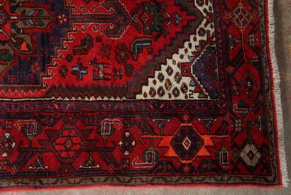 null Polychrome wool carpet decorated with a central hexagonal medallion on a red...
