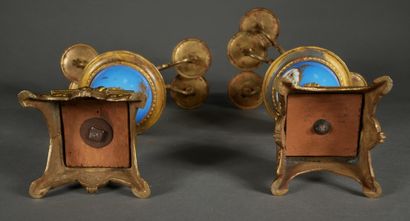null A pair of bronze and porcelain candelabras decorated with flowers in medallions...