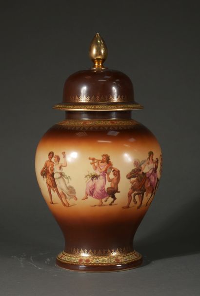 null A polychrome and gilt porcelain covered baluster jar with a bachannale decoration...