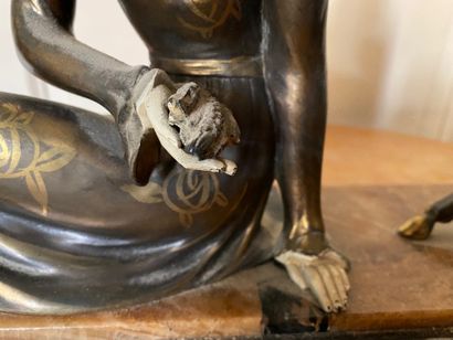 null Sculpture in regula and patinated plaster representing a young woman sitting...