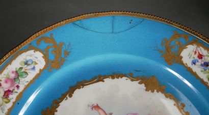 null Lot :

- Tripod gilt metal display stand and a polychrome porcelain soup plate...