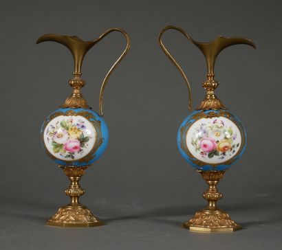 null A pair of polychrome porcelain buirettes with flowers in a medallion on a turquoise...