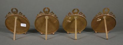 null Four round bronze and brass picture frames, pediment with bow and laurel crown,...