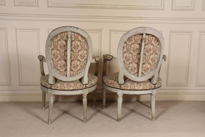 null Two cabriolet armchairs with medallion backs, one with fluted tapered legs and...