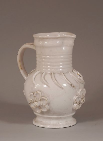 null Earthenware pitcher with cream engobe and flowers in relief

H : 30 cm. (ch...