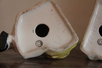 null Pair of polychrome porcelain bookends decorated with child musicians, German...