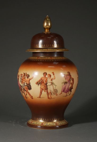 null A polychrome and gilt porcelain covered baluster jar with a bachannale decoration...
