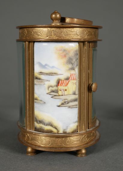 null Lot of three clocks:

- ELLIOTT SON

Oval brass officer's clock with landscape...