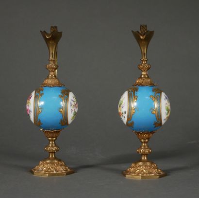 null A pair of polychrome porcelain buirettes with flowers in a medallion on a turquoise...
