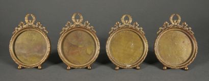 null Four round bronze and brass picture frames, pediment with bow and laurel crown,...